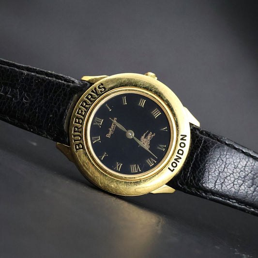 Burberrys London | Gold Round | Engraved Bezel | Black Roman Dial