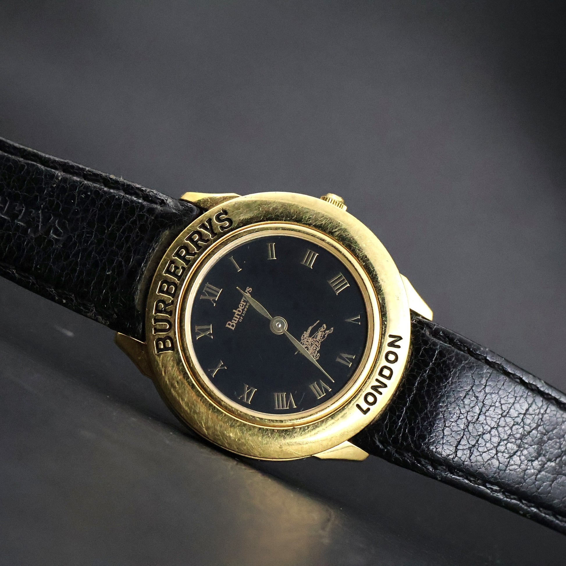 Burberrys London | Gold Round | Engraved Bezel | Black Roman Dial