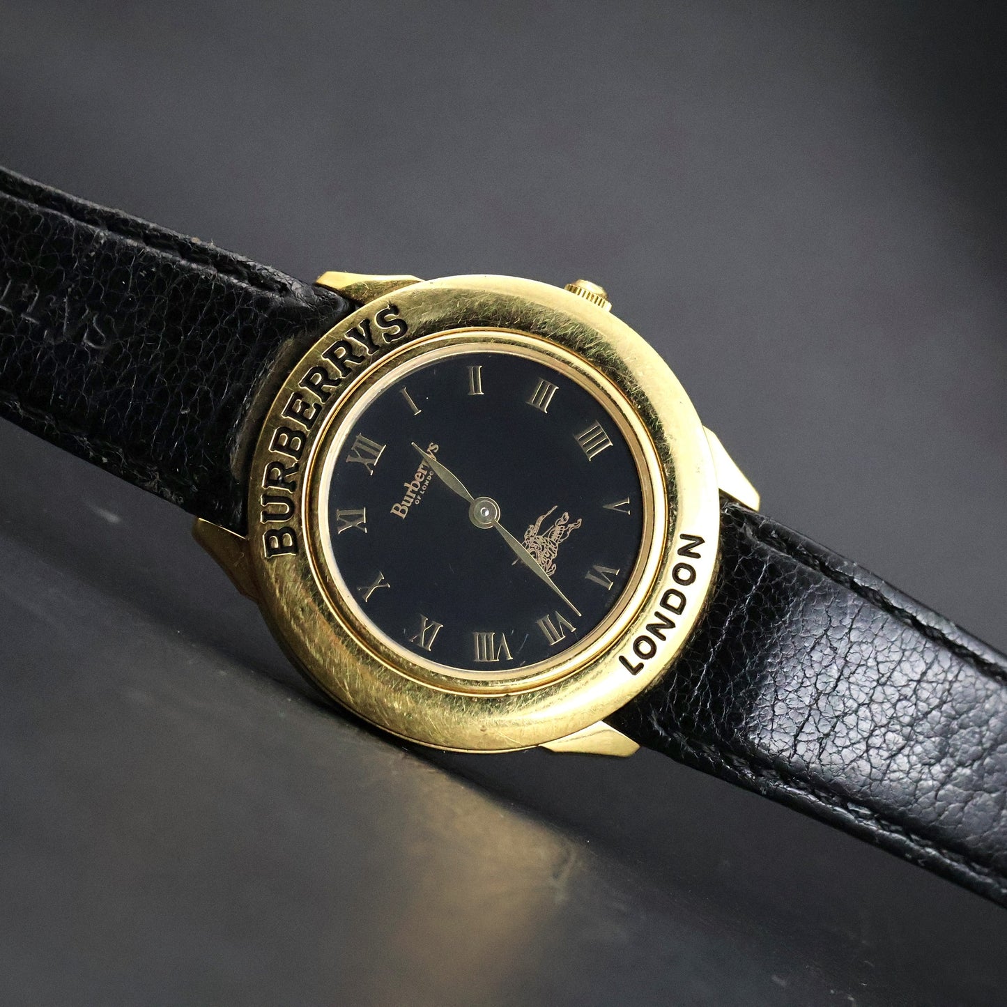 Burberrys London | Gold Round | Engraved Bezel | Black Roman Dial
