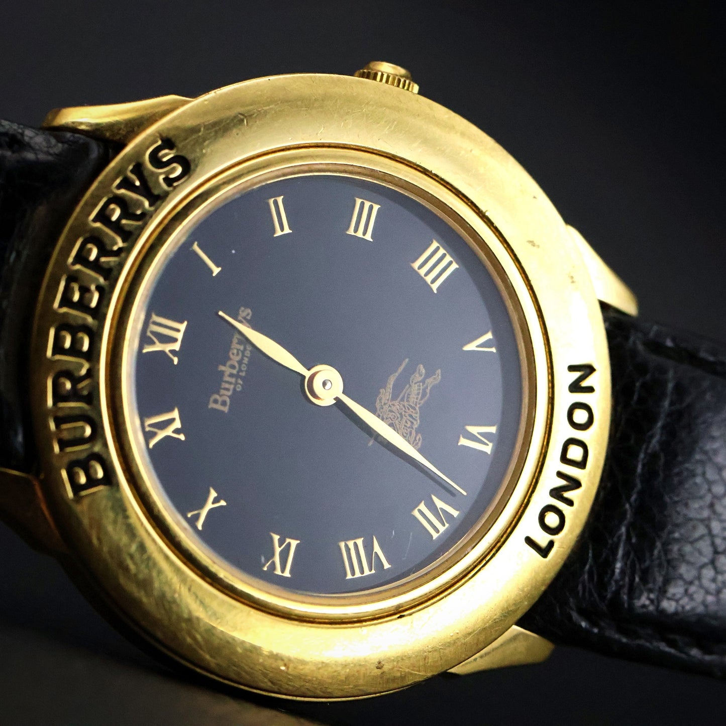 Burberrys London | Gold Round | Engraved Bezel | Black Roman Dial