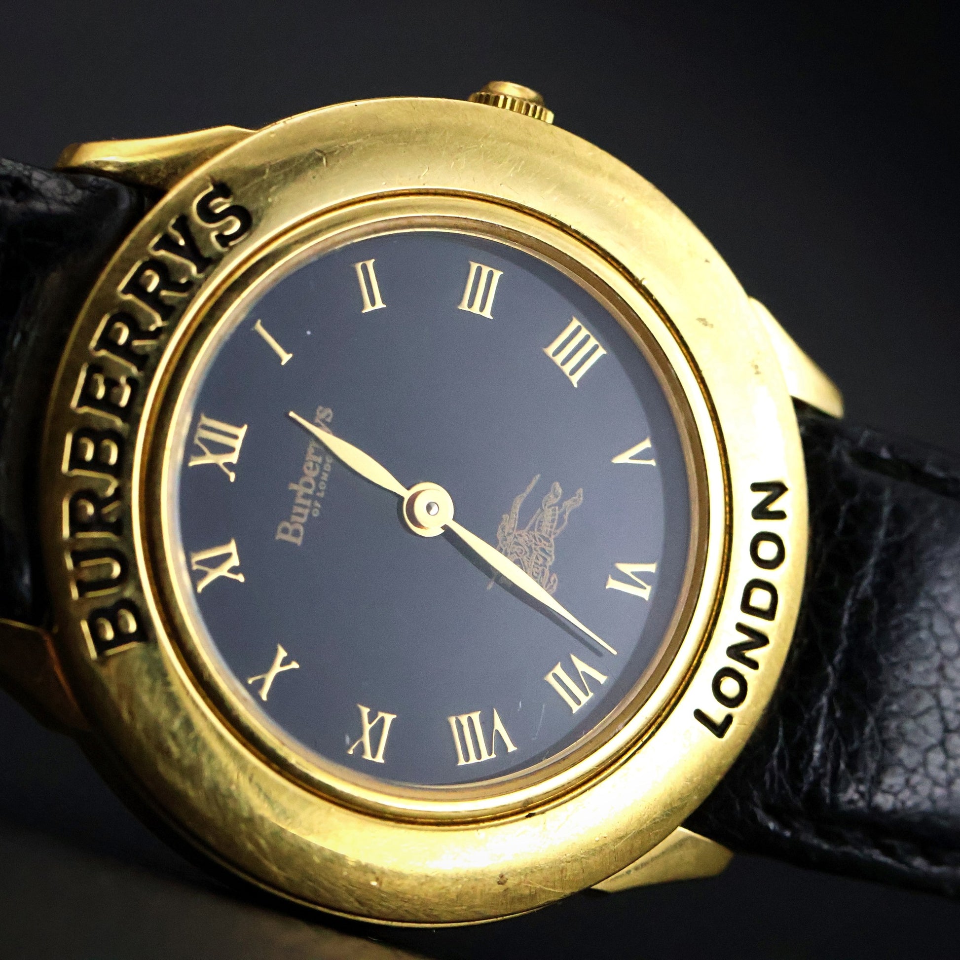 Burberrys London | Gold Round | Engraved Bezel | Black Roman Dial