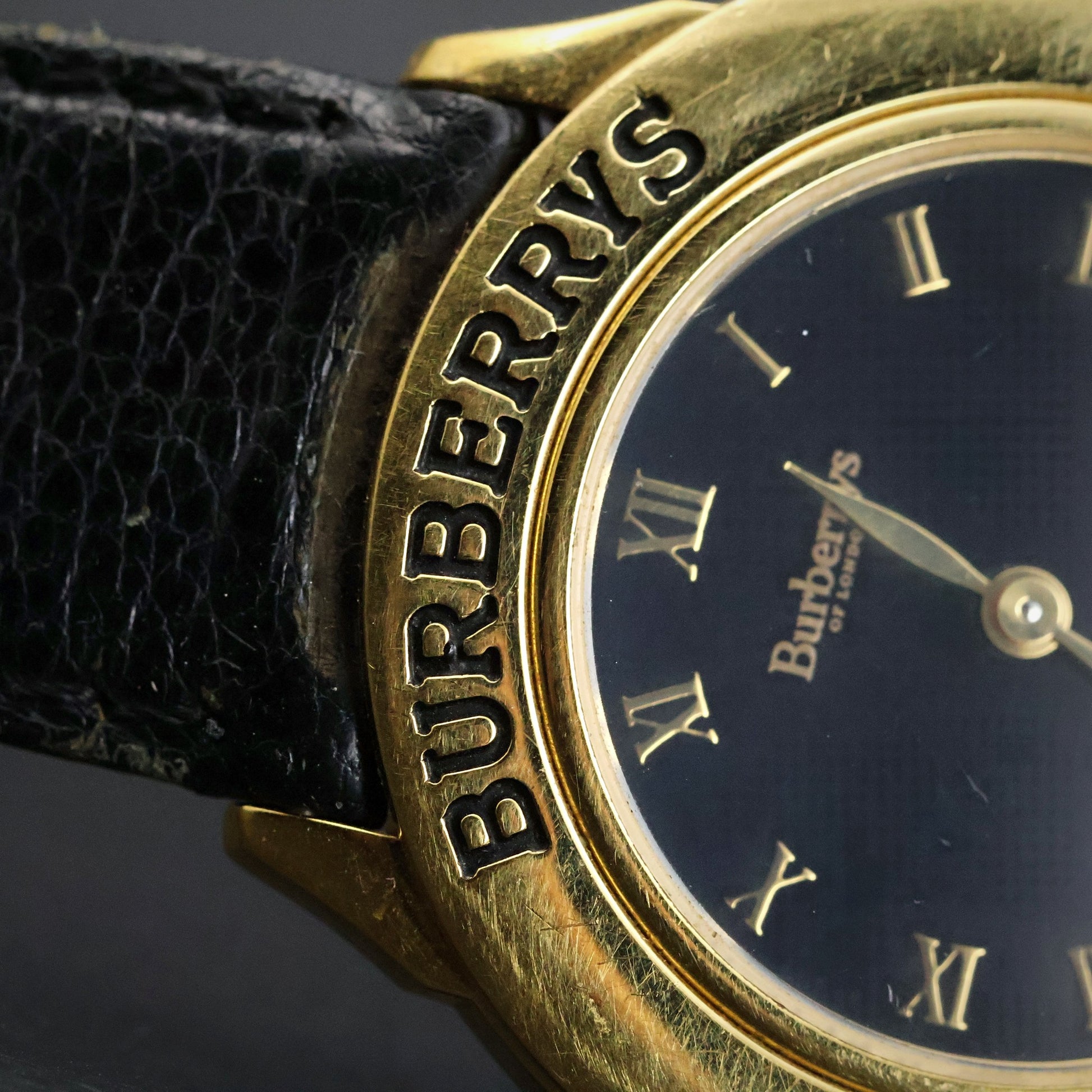 Burberrys London | Gold Round | Engraved Bezel | Black Roman Dial