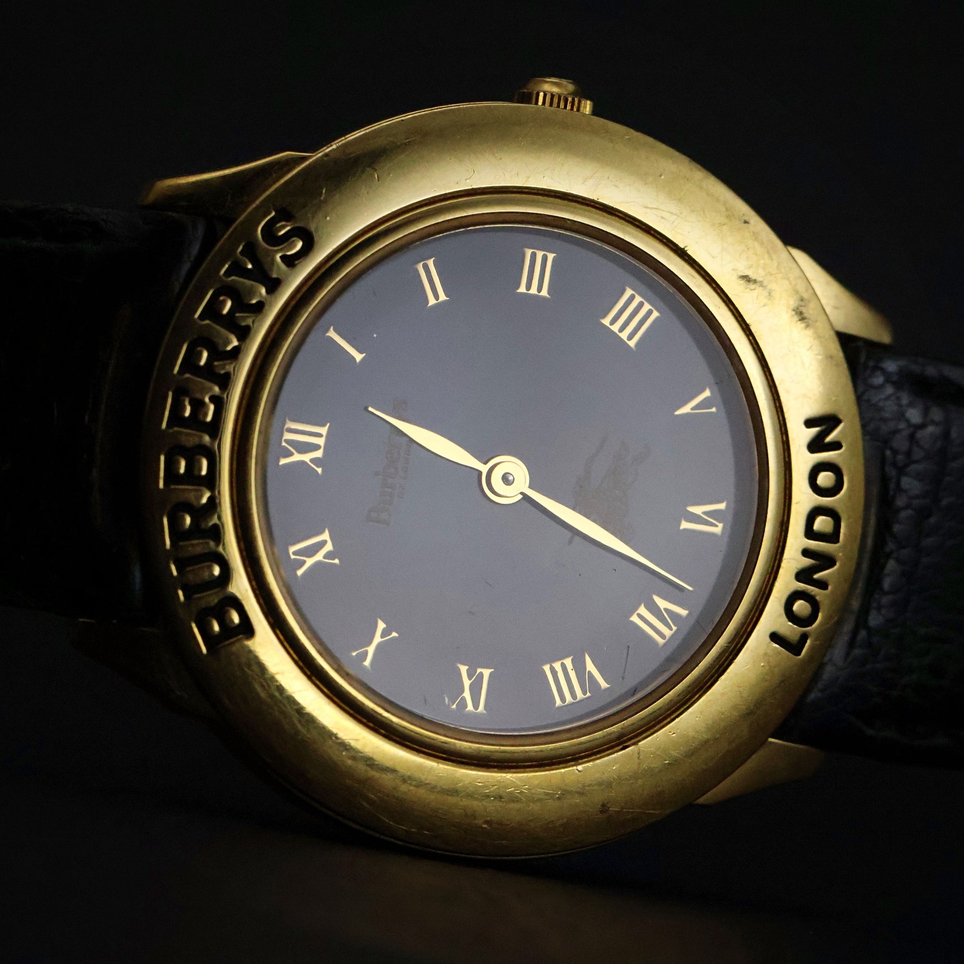 Burberrys London | Gold Round | Engraved Bezel | Black Roman Dial