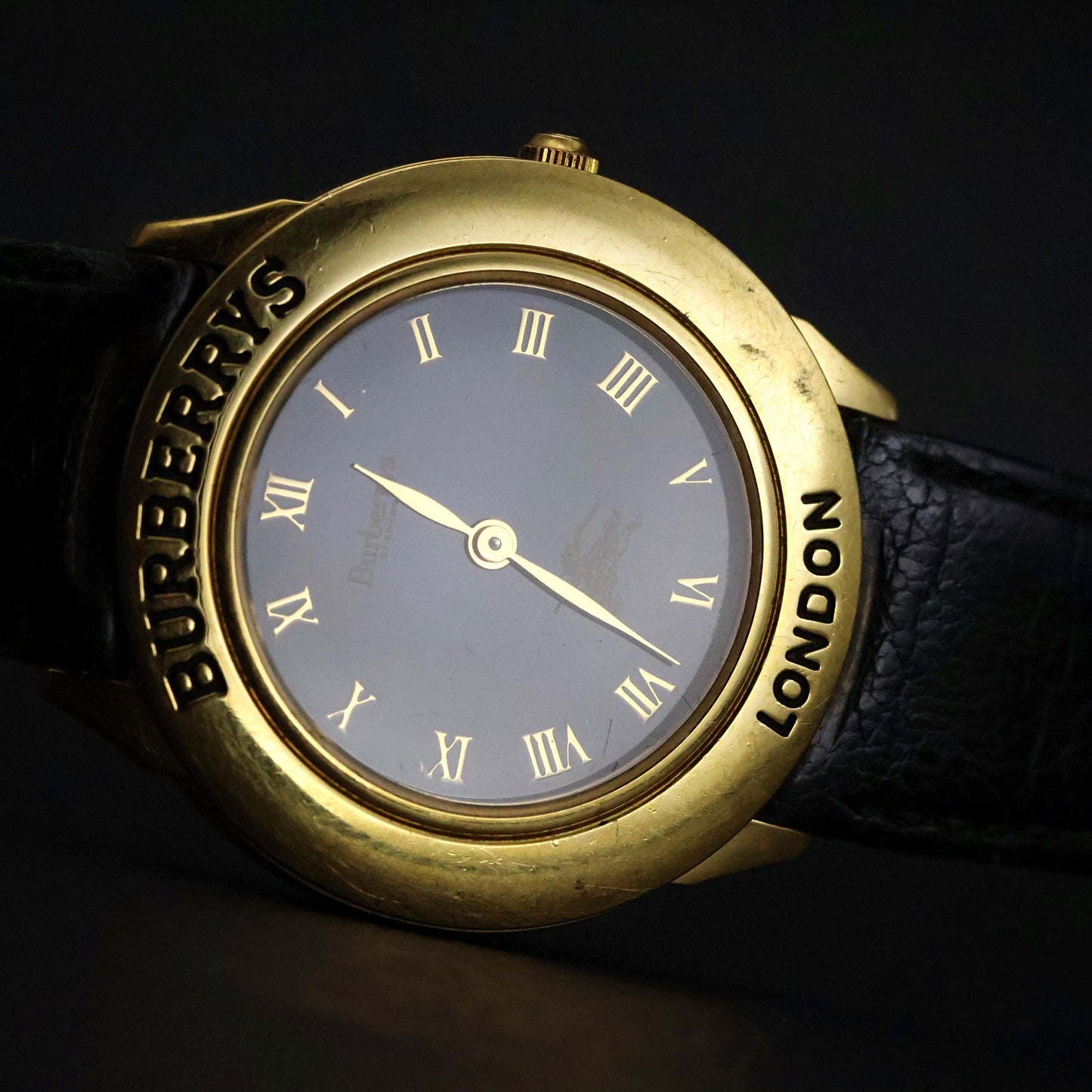 Burberrys London | Gold Round | Engraved Bezel | Black Roman Dial